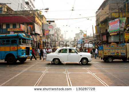 stock-photo-kolkata-india-jan-antique-white-ambassador-car-down-the-busy-street-on-january-in-130287728.jpg